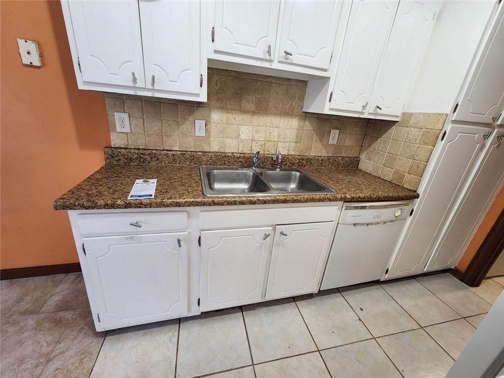 3186 Quince Tree Lane Decatur, GA 30034 - Photo 9 of 24 a kitchen with stainless steel appliances granite countertop a sink and a white cabinets