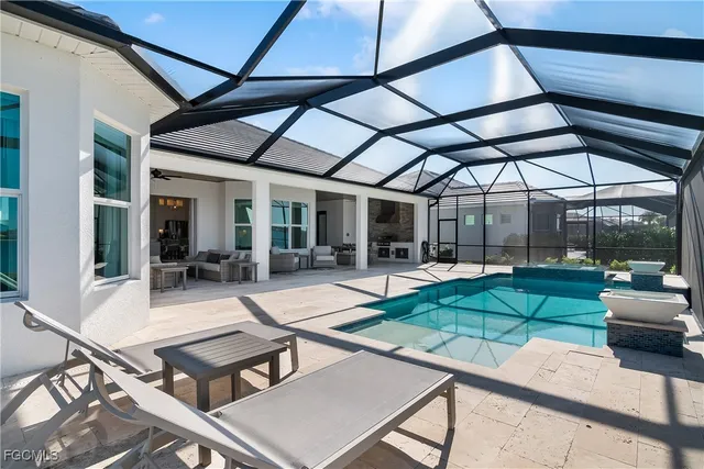 a swimming pool with outdoor seating and yard