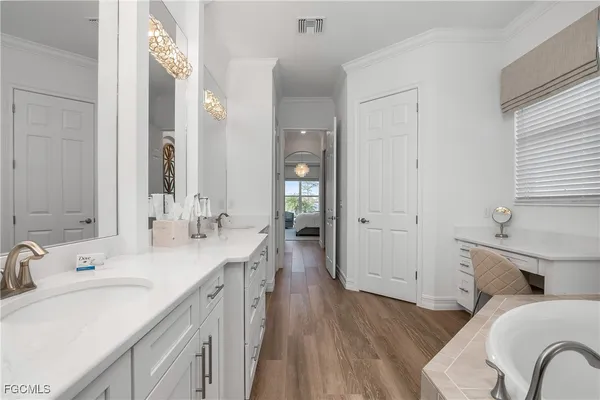 a spacious bathroom with a granite countertop sink a toilet and a mirror