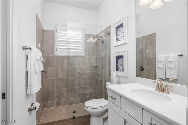 a bathroom with a sink toilet and shower