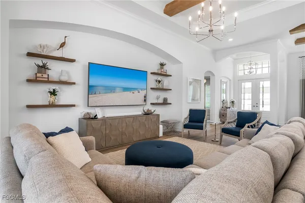 a living room with furniture a chandelier and a chandelier