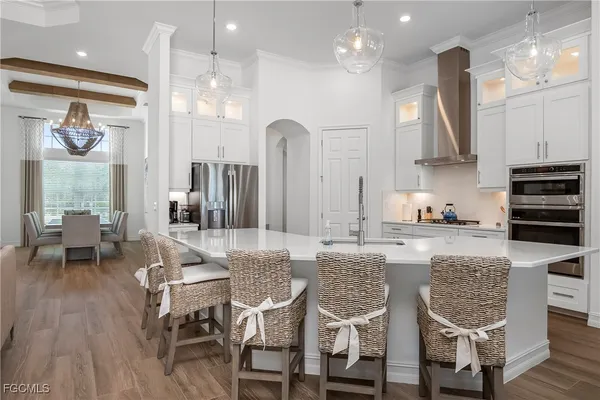 a kitchen with stainless steel appliances granite countertop a kitchen island a stove a table and chairs in it