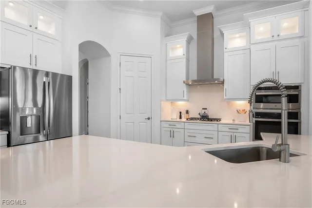 a kitchen with stainless steel appliances a refrigerator sink and cabinets