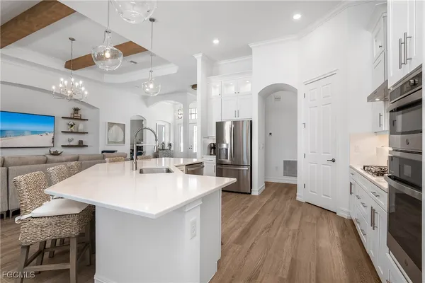 a large kitchen with a large counter top appliances and cabinets