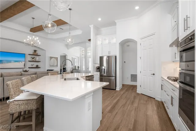 a large kitchen with a large counter top appliances and cabinets