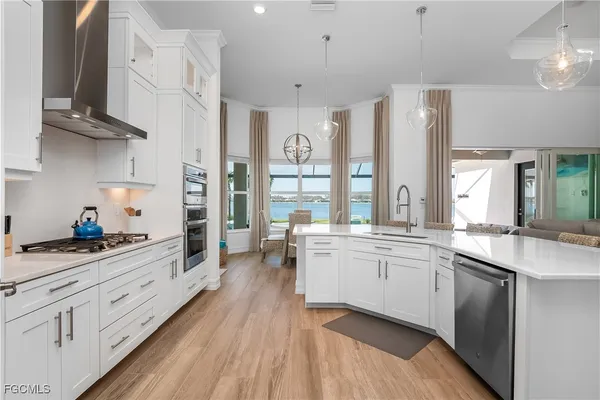 a open kitchen with stainless steel appliances granite countertop a lot of counter space and wooden floors