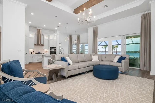 a living room with furniture and a chandelier