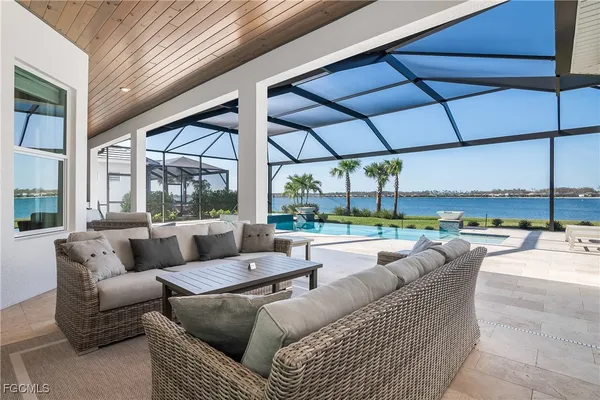 a living room with furniture and a floor to ceiling window