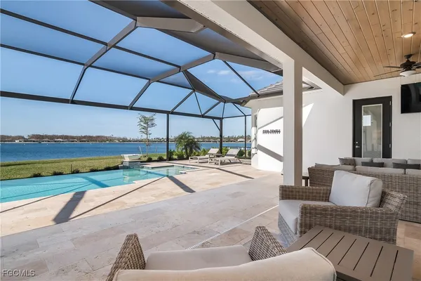 a view of a patio with couches and pool