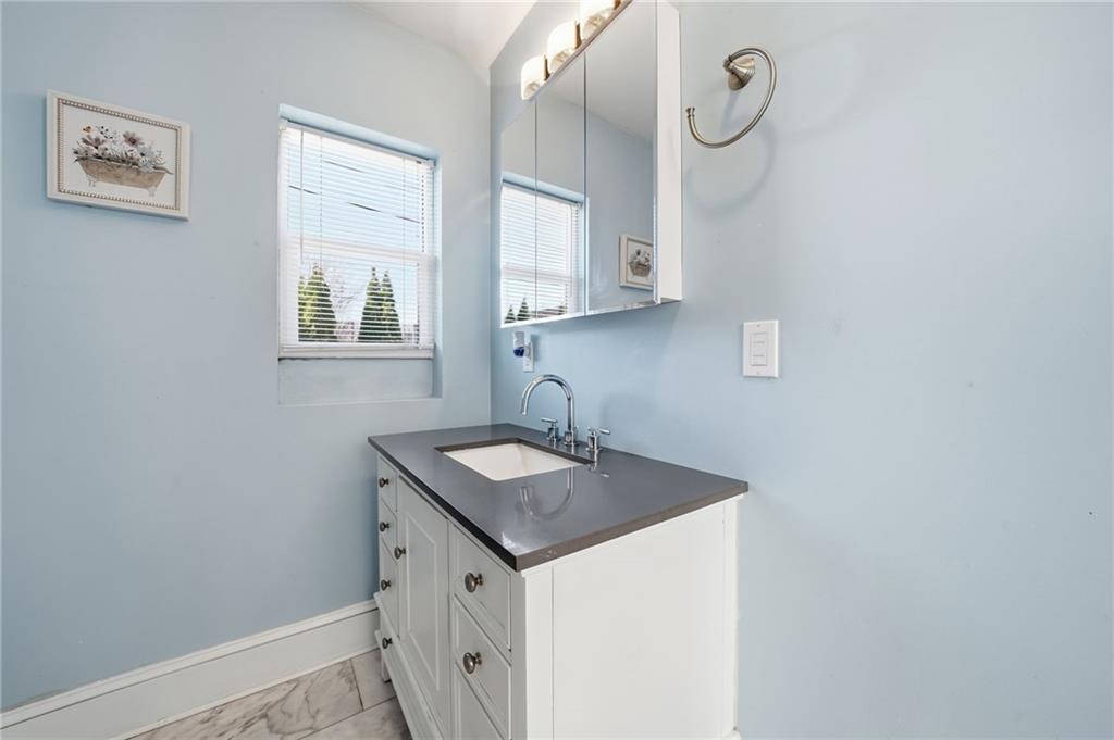 1420 Sylvan Road Southwest Atlanta, GA 30310 - Photo 11 of 51 a bathroom with a sink a vanity and a mirror