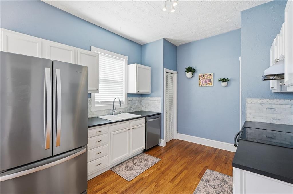 1420 Sylvan Road Southwest Atlanta, GA 30310 - Photo 14 of 43 a kitchen with granite countertop a refrigerator and a sink