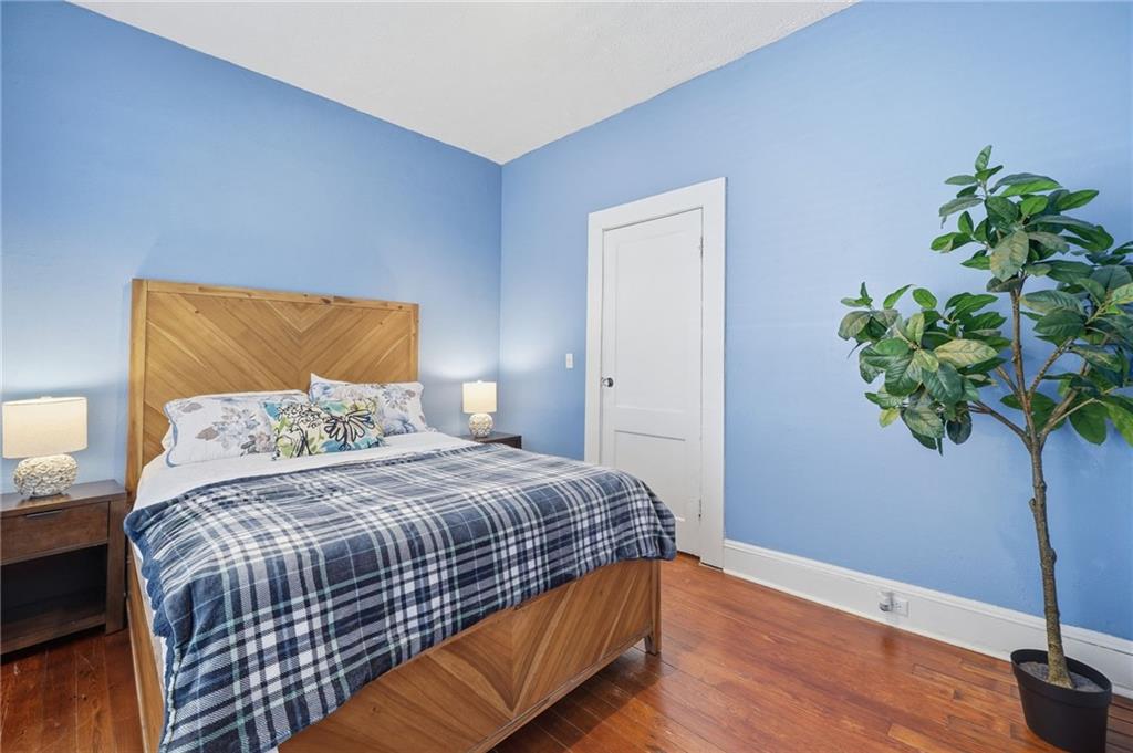 1420 Sylvan Road Southwest Atlanta, GA 30310 - Photo 14 of 51 a bedroom with a bed potted plant and a lamp