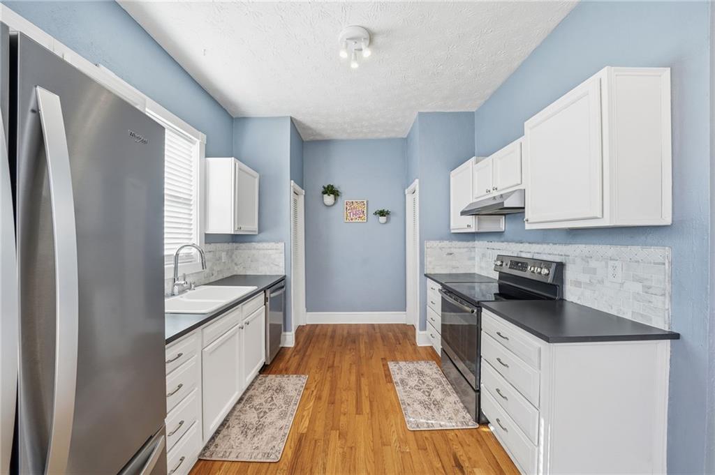 1420 Sylvan Road Southwest Atlanta, GA 30310 - Photo 19 of 51 a kitchen with granite countertop a sink stove and refrigerator