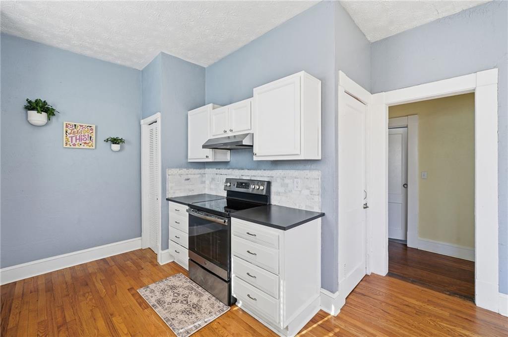 1420 Sylvan Road Southwest Atlanta, GA 30310 - Photo 21 of 51 a kitchen with white cabinets and appliances