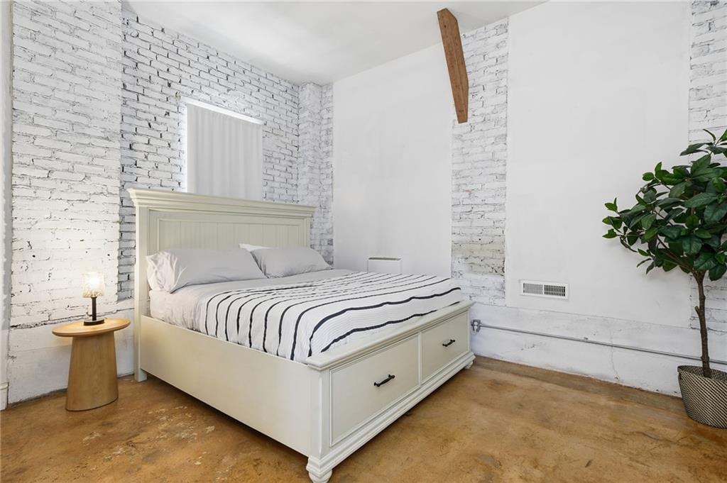 1420 Sylvan Road Southwest Atlanta, GA 30310 - Photo 24 of 43 a spacious bedroom with a bed and a potted plant