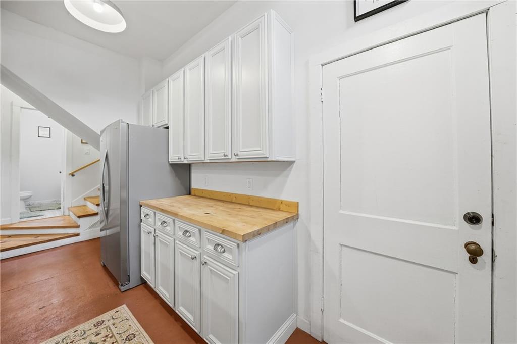 1420 Sylvan Road Southwest Atlanta, GA 30310 - Photo 28 of 43 a kitchen with a refrigerator a stove a washer and dryer