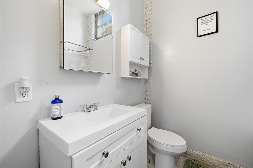 1420 Sylvan Road Southwest Atlanta, GA 30310 - Photo 30 of 43 a bathroom with a sink toilet and a mirror