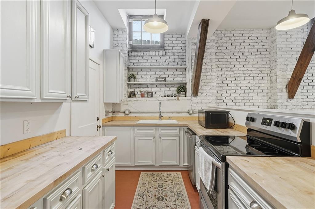 1420 Sylvan Road Southwest Atlanta, GA 30310 - Photo 32 of 51 a kitchen with a sink stove and cabinets
