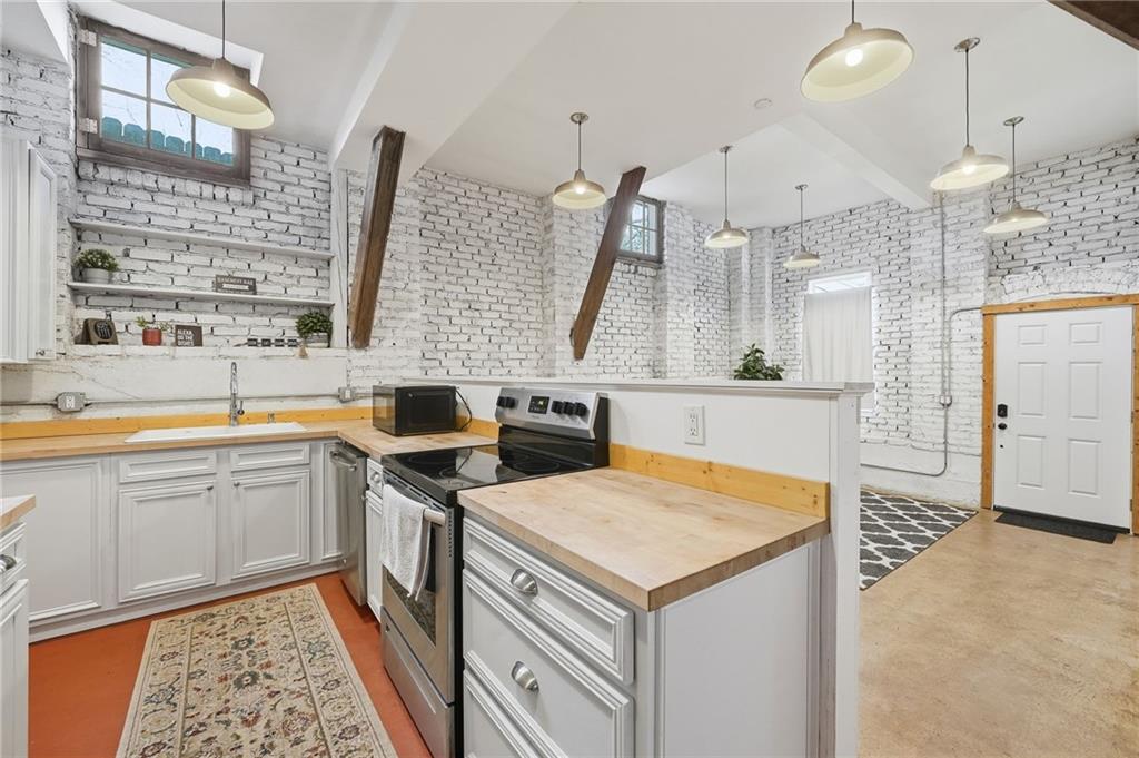 1420 Sylvan Road Southwest Atlanta, GA 30310 - Photo 34 of 51 a kitchen that has a lot of cabinets in it and wooden floor