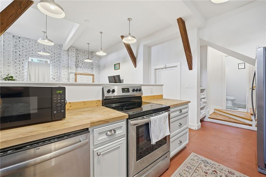 1420 Sylvan Road Southwest Atlanta, GA 30310 - Photo 36 of 51 a kitchen with a stove and a wooden floor
