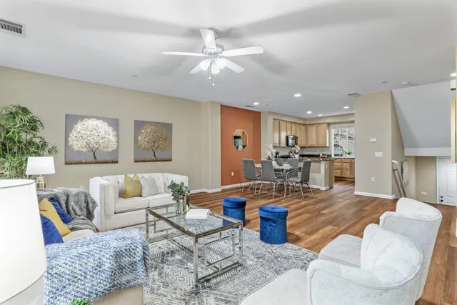 a living room with furniture and kitchen view