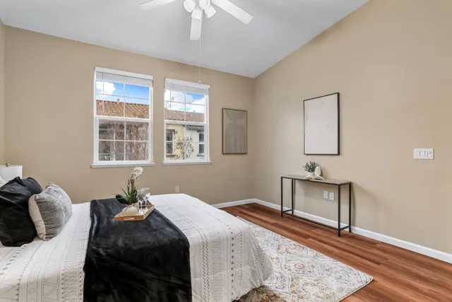 a bedroom with a bed lamp closet and window