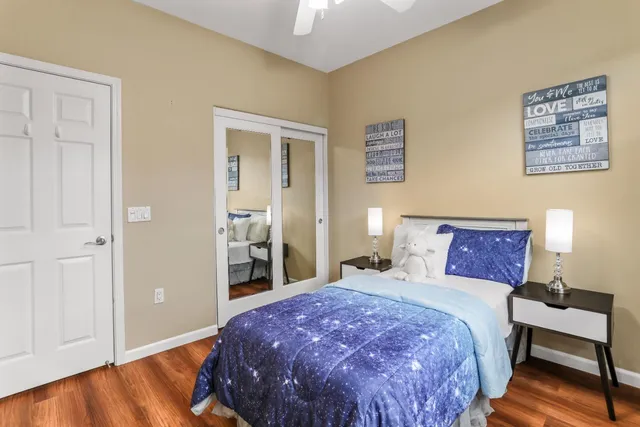 a bedroom with a large bed and a chandelier