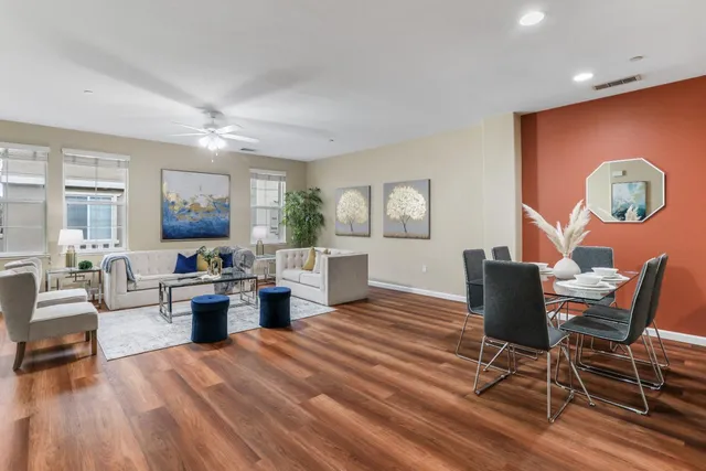 a living room with furniture and a wooden floor