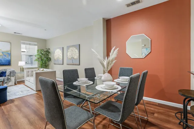 a dining room with furniture and wooden floor