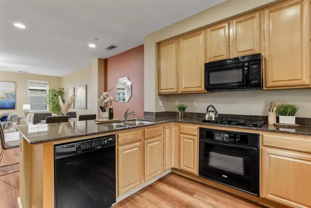 a kitchen with a sink stove and microwave