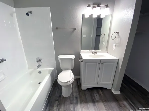 a bathroom with a sink toilet a mirror and shower