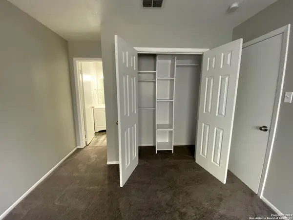 a view of an empty room with a fireplace