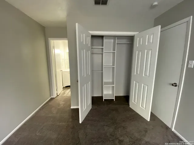 a view of an empty room with a fireplace