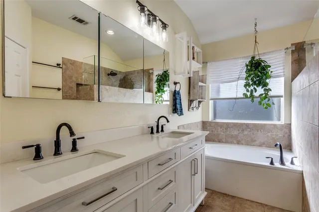 a bathroom with a double vanity sink and a bathtub