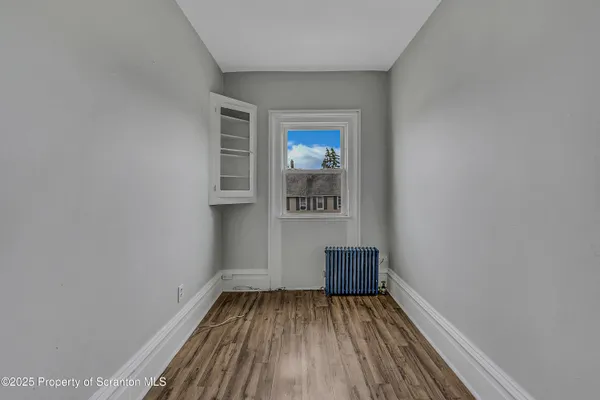 a view of a room with wooden floor