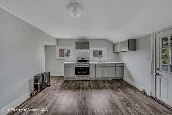 a kitchen with sink cabinets and wooden floor