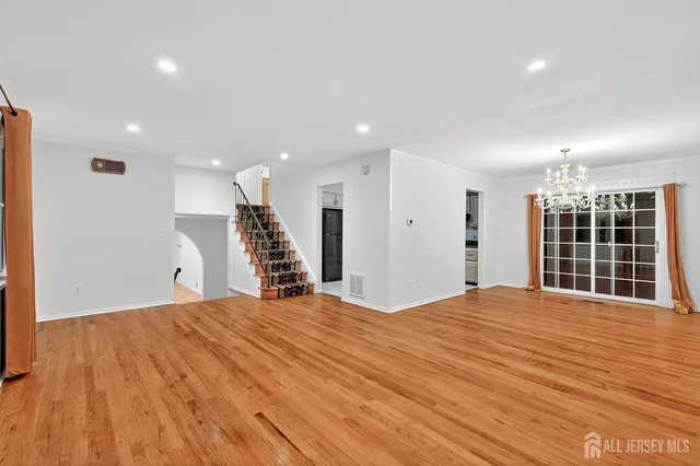 a view of a kitchen with wooden floor and a sink