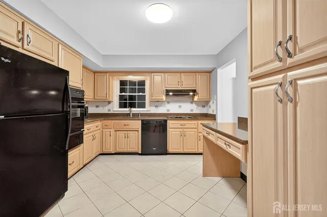 a kitchen with stainless steel appliances granite countertop a stove a refrigerator and a sink