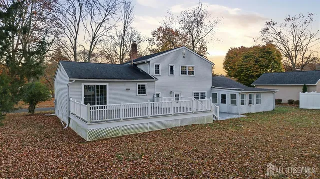 a view of backyard with deck and a garden