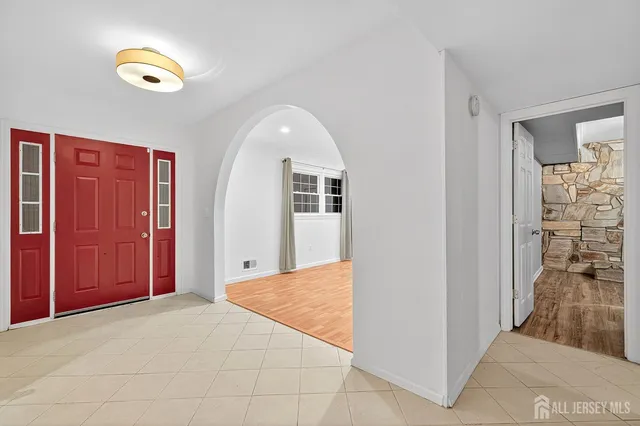 an empty room with windows and closet