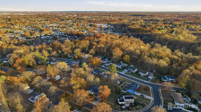 an aerial view of lake and residential houses with outdoor space
