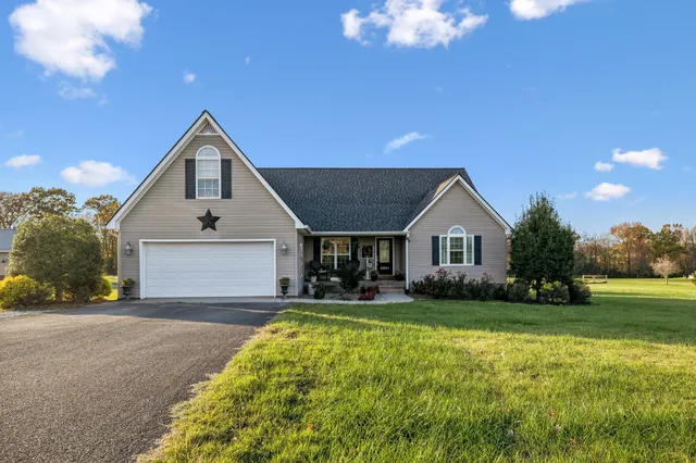 a front view of house with yard and green space