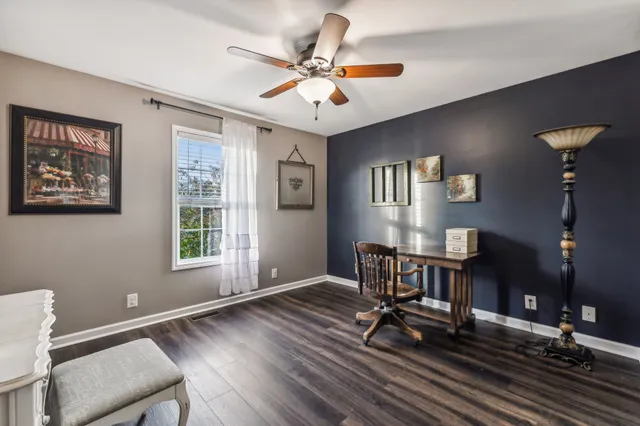a workspace with wooden floor and windows