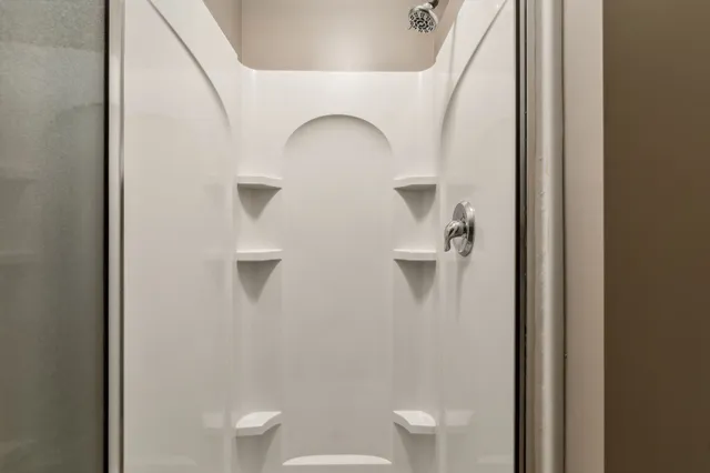 a bathroom with a toilet a sink and shower