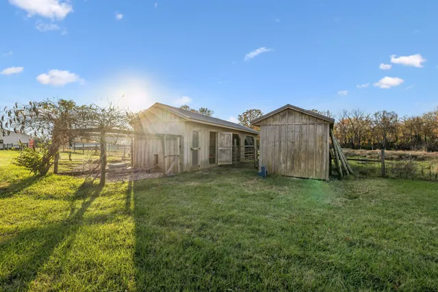 a view of a house with a yard and a garden