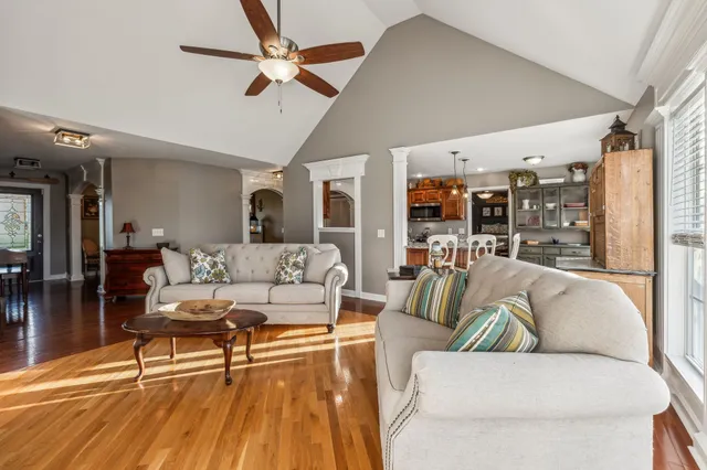 a living room with furniture and a chandelier