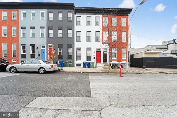 a view of a street that has couple of cars parked on the road