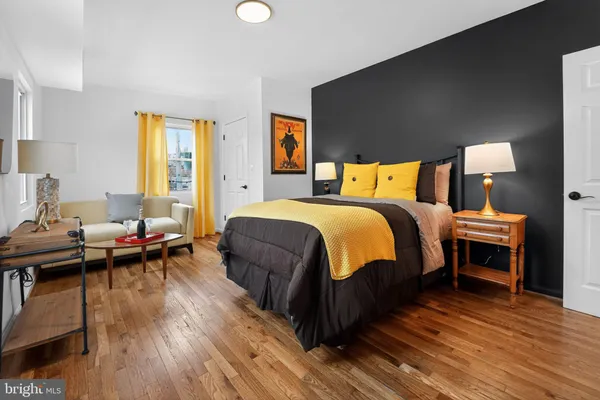 a bedroom with a bed and a wooden floor
