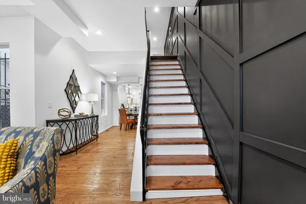 a view of entryway and hall with wooden floor