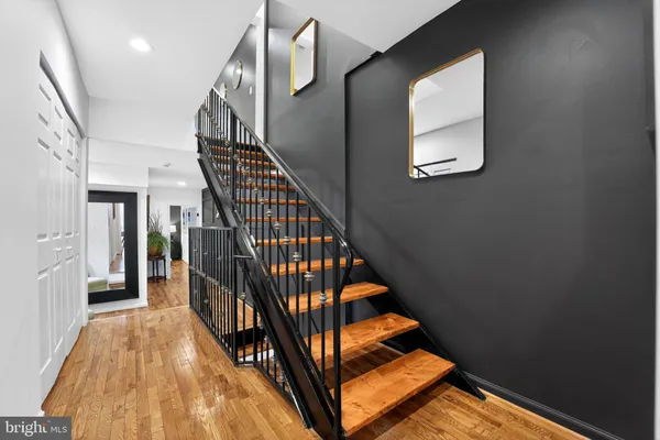 a view of entryway and hall with wooden floor